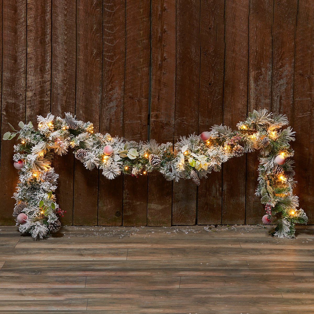 207577-z1.jpg White Flocked 9-Ft. Cordless Pre-Lit Indoor/Outdoor Garland - Image 1
